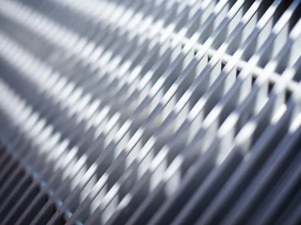 Industrial radiators feature intersecting metallic lines creating a dynamic, patterned surface
